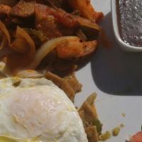 Chilaquiles · Sautéed tortilla strips, tomato, poblano peppers, onions with scrambled or fried eggs, toppe...