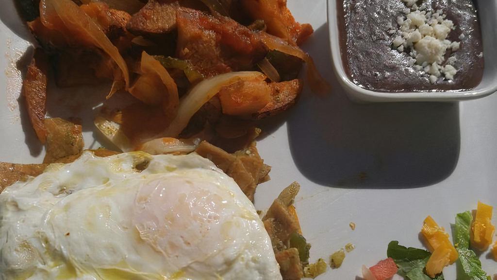 Chilaquiles · Sautéed tortilla strips, tomato, poblano peppers, onions with scrambled or fried eggs, topped with green tortilla sauce and melted cheese.