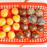 Dozen Chocolate Glazed Donut Holes · Bag of dozen chocolate glazed donut holes. (Sprinkles available).