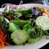 Spinach Salad · Grilled chicken atop a bounty of spinach with feta, walnuts, carrots, red onion, cucumber, a...