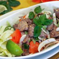 Grilled Beef Salad · Grilled beef with chilies and lime vinaigrette on a bed of baby greens.