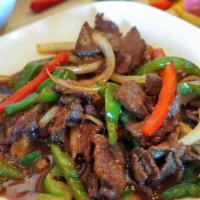 Thai Pepper Steak · Stir-fried flank steak with bell peppers and onions in a Thai brown sauce. Served with jasmi...