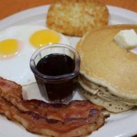 Pancake Plate · Two eggs, two pancakes, one hash brown patty, choice of bacon or ham.