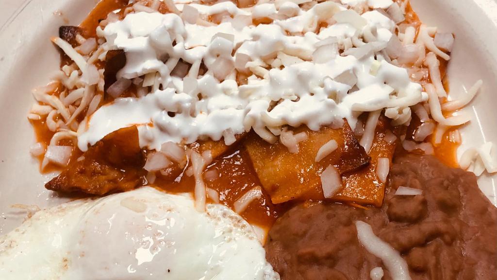 Chilaquiles · Corn tortilla pieces lightly fried topped with salsa, cheese, onions, and sour cream. Served with two eggs and beans.