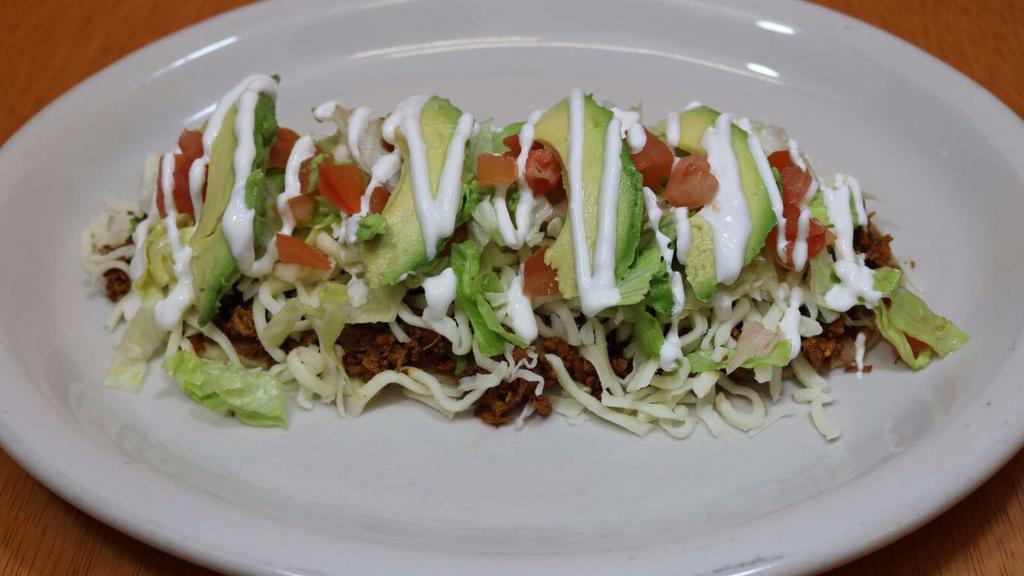 Huarache · Prepared with your choice of meat, beans, cilantro, onions, cheese, lettuce, avocado, tomatoes, and sour cream.