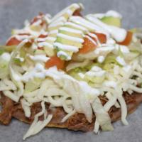 Tostada · Prepared with your choice of meat, beans, cilantro, onions, cheese, lettuce, avocado, tomato...