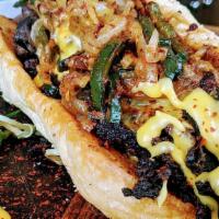 Bulgogi Cheesesteak · thinly sliced ribeye bulgogi, fried chili onions & poblano, cheese sauce, Gambino's French b...
