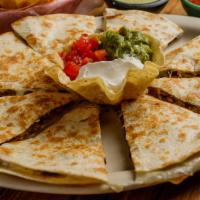 Quesadillas · Grilled home-made flour tortillas stuffed with chicken and melted Monterrey jack cheese.