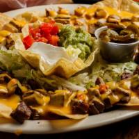 Nachos With Beef Fajita · Topped with beef fajita beans, melted cheese, guacamole, sour cream, jalapeños.