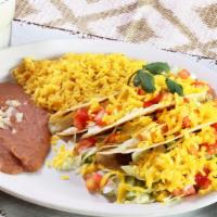 Crispy Tacos · Ground beef or ranchero chicken served with rice and re-fried beans (tacos served with lettu...
