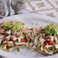 Soft Tacos · Ground beef or ranchero chicken served with rice and re-fried beans (tacos served with lettu...