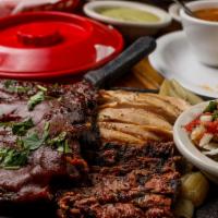 Baby Back Ribs · Tender pork baby back ribs glazed with our delicious barbeque sauce, then layered over a bed...