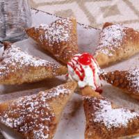 Sopapillas (6 Pieces) · Homemade light pastries topped with powered cinnamon and sugar.