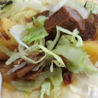 Res (Beef) Taco · Beef taco, topped with lettuce and tomato.