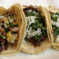 Pastor Taco · Marinated pork taco, topped with cilantro and onions.