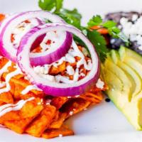 Chilaquiles · Corn chips, salsa roja, queso fresco, red onion, topped with sour cream and served with refr...