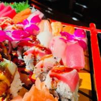 Omakase Deluxe · Salad, chef's choice of 7 pieces sushi, 7 pieces sashimi & 2 choice of any chef's special ro...