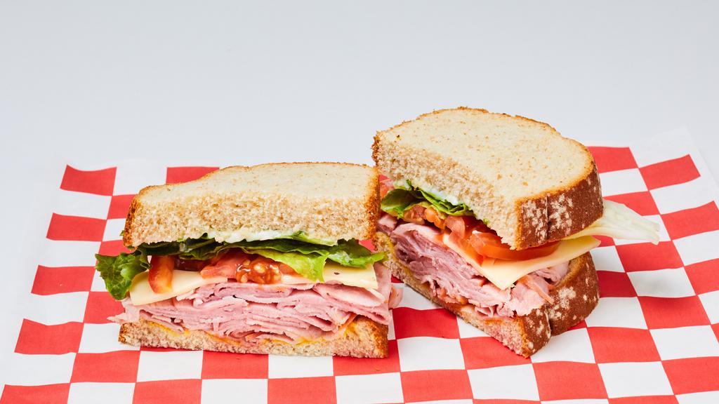 Ham & Swiss Cheese Sandwich · Boar's Head Ham and Swiss Cheese, Lettuce, Tomato, Mayo and Mustard on Wheat Bread