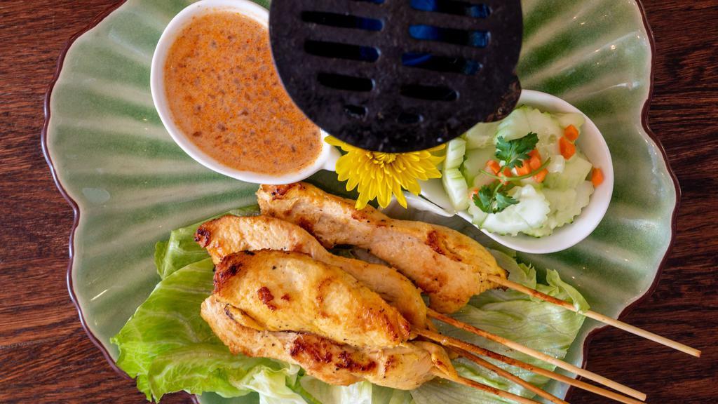 Chicken Satay · Marinated chicken on a stick serves with peanut sauce and cucumber salad.