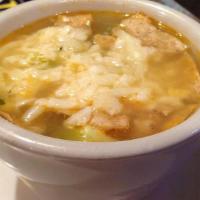 Tortilla Soup · Chicken and vegetables topped with tortilla strips, avocado cheese and cilantro in a broth.