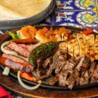 La Parillada · Beef, chicken, shrimp and sausage with grilled peppers and onions, served with charro beans,...