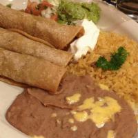 Tacos Al Carbon · Three flour tortillas filled with beef or chicken fajita served with rice, refried beans, gu...
