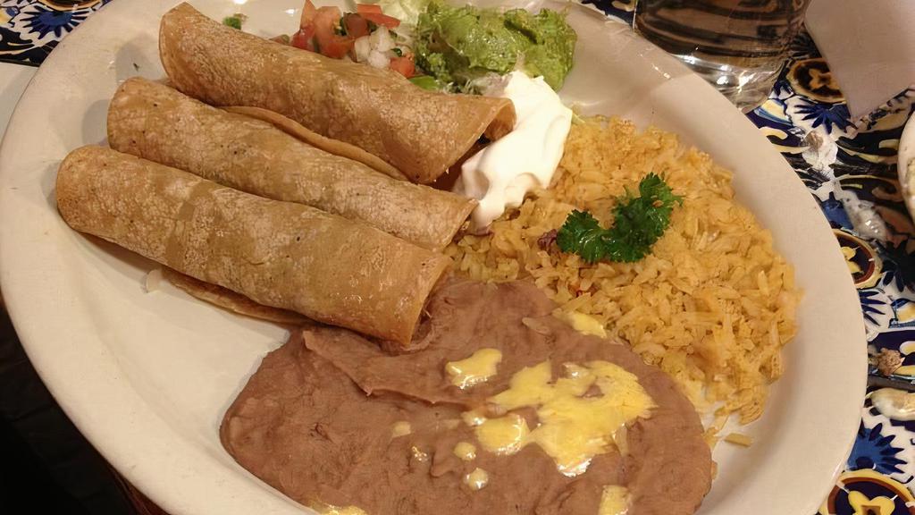 Tacos Al Carbon · Three flour tortillas filled with beef or chicken fajita served with rice, refried beans, guacamole, sour cream and pico de gallo.