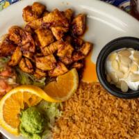 Long Horn Special Pollo Adobado · Tender chunks of chicken sautéed in chile ancho sauce served with rice, guacamole, and sour ...