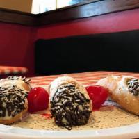 Mini Cannoli · Filled with sweet ricotta cream, chocolate chips, garnished with pistacchios and maraschino ...