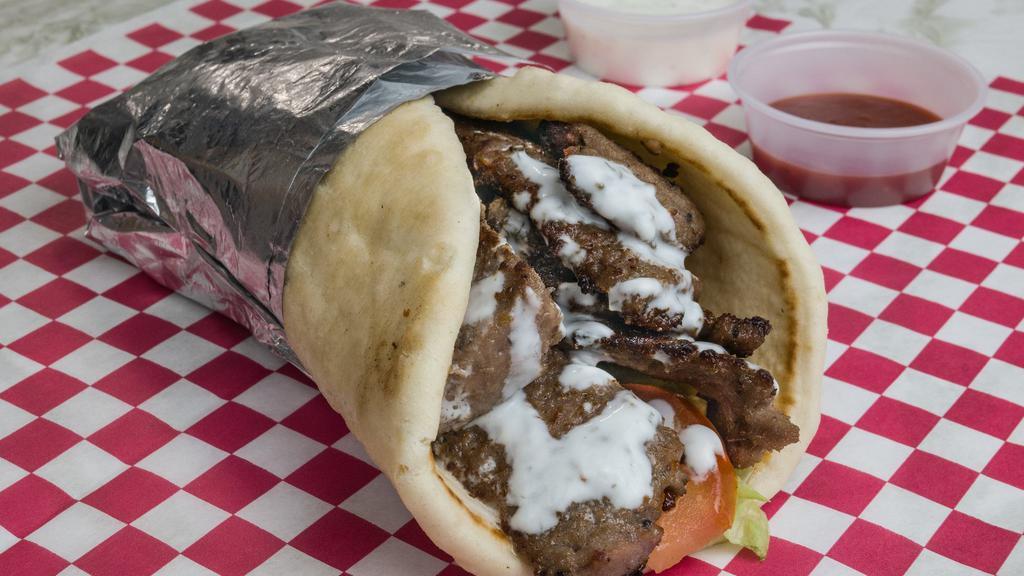 Gyro Wrap · Halal Beef Gyro wrap, comes with lettuce, tomatoes, onions, and our special delicious white sauce!