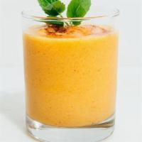 Mango Lassi · Refreshing Mango drink with Yogurt and flavored with cardamom served in a 10 Oz glass which ...