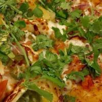 Pav Bhaji Pizza · Indian style pizza with mixed/mashed Veggie Stew generously spread on the Pizza. A decent si...