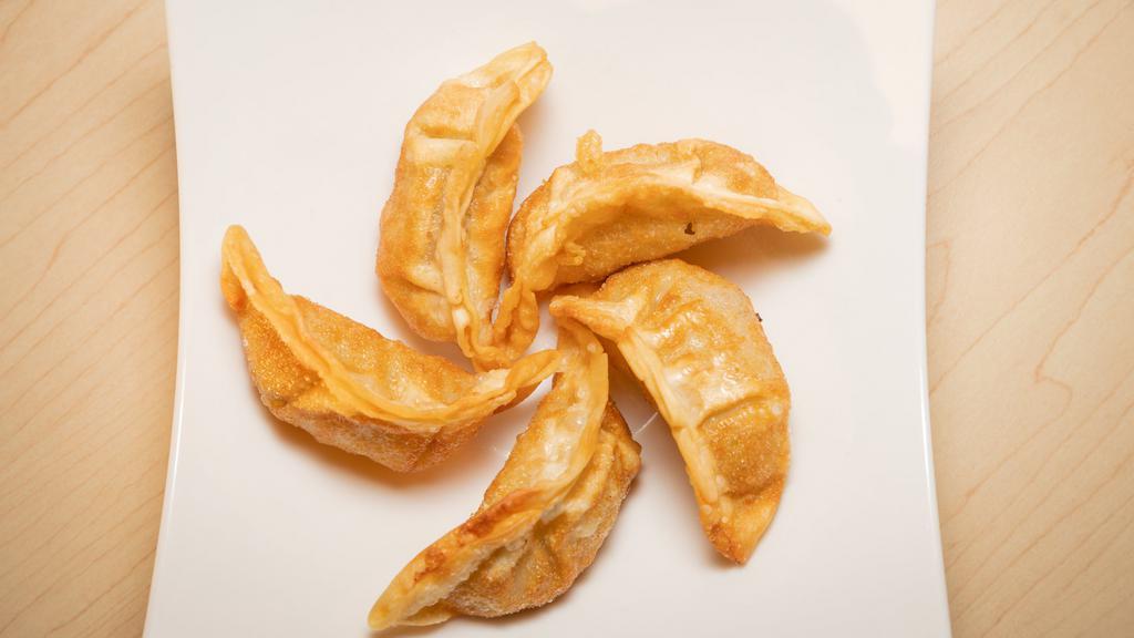 Gyoza · Six pieces of fried Japanese dumplings filled with pork and vegetables.