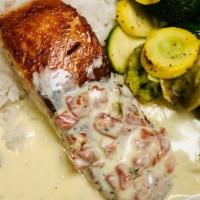 Salmon · GRILLED OR BLACKENED SALMON SERVED WITH A TOMATO DILL CREAM SAUCE. COMES WITH MASHED POTATOE...