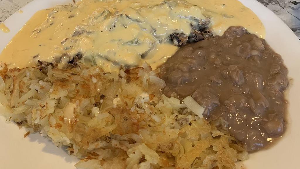 Lucy'S Famous Machaca Breakfast · Shredded beef or chicken with tomatoes, onions, and eggs smothered in a generous serving of Lucy's own chile con queso