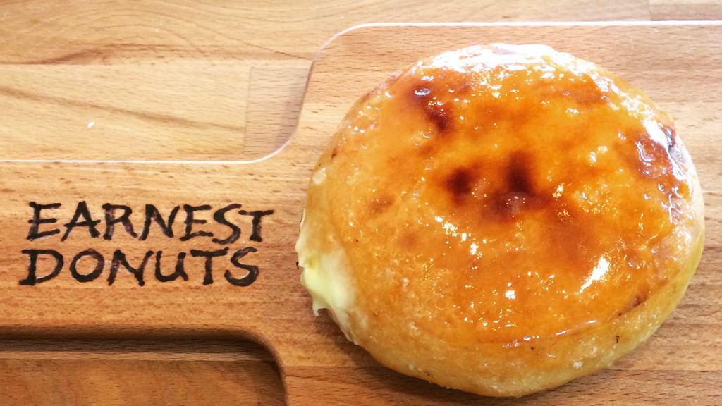 Creme Brulee · Crunchy caramelized sugar topping on a raised yeast donut with bavarian cream filling.