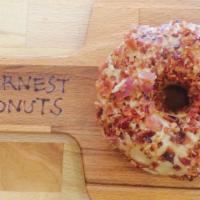Maple Bacon · Raised donut frosted with maple icing and covered in bacon crumbles (cooked and crumbled fre...