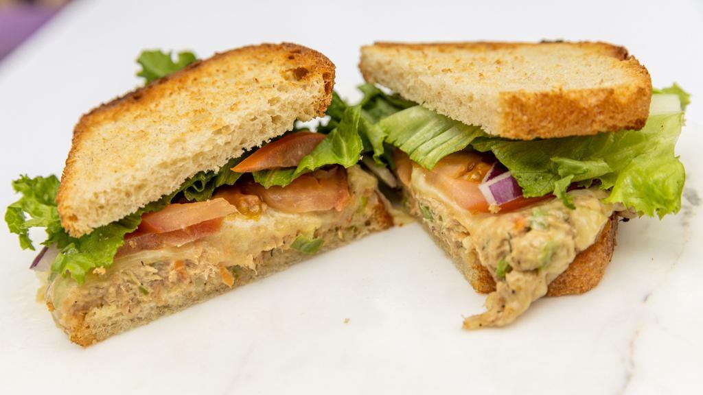 Tuna Melt · On toasted bakehouse sourdough, with housemade tuna salad, sharp cheddar, lettuce, tomatoes, and red onion.
