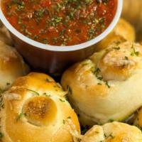 Cheesy Garlic Knots (10 Pc) · 10 pieces of Knots rolled in Garlic butter topped with cheese and dried parsley. Served with...