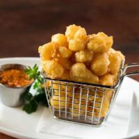 Cheese Curds · White cheddar, cornmeal battered, smoked tomato coulis.