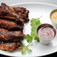 Smoked Chicken Wings · Grilled chili-rubbed wings, BBQ sauce, Carolina mustard BBQ sauce.