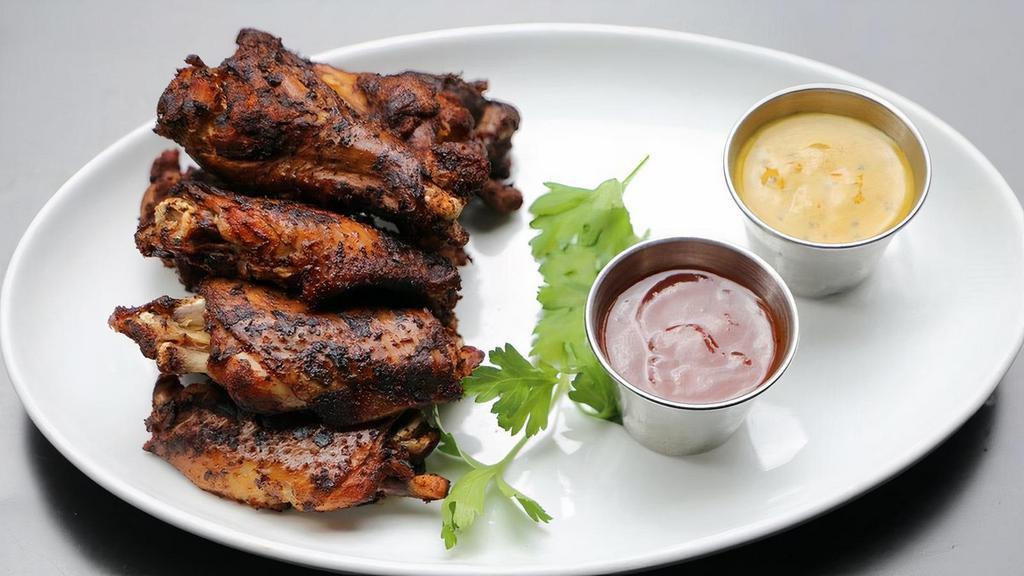 Smoked Chicken Wings · Grilled chili-rubbed wings, BBQ sauce, Carolina mustard BBQ sauce.