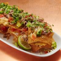 Duck Nachos · Pulled confit duck, pepper jack cheese sauce, pickled jalapenos, smoked tomatoes, red onion,...