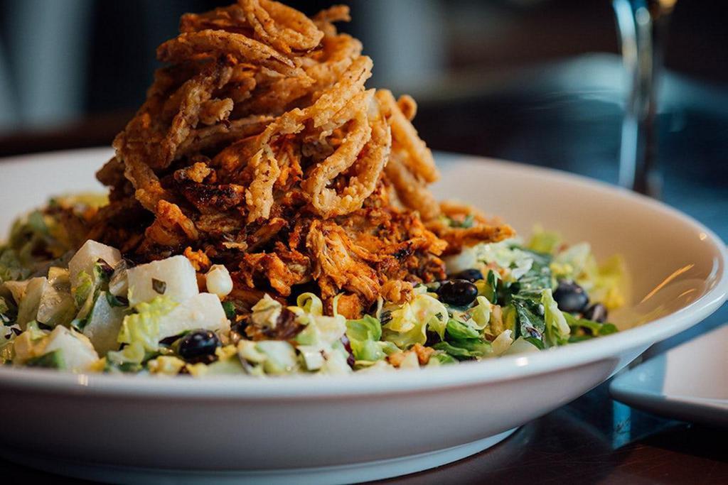 Bbq Chicken Chopped Salad · Smoked pulled BBQ chicken, romaine, iceberg, red leaf, tomatoes, cucumbers, black beans, roasted corn, jicama, crispy buttermilk onion rings, ranch dressing.