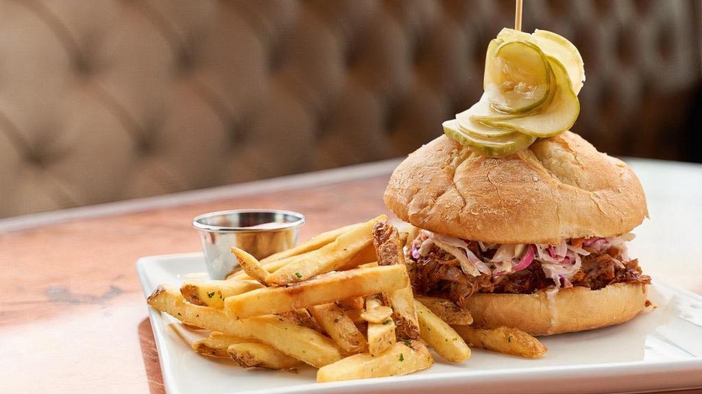 Pulled Pork Sandwich · Hand pulled hardwood-smoked pork shoulder, BBQ sauce, cider mustard, coleslaw, spicy bread and butter pickles.