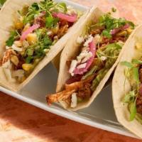 Chicken Tinga Tacos · House-smoked spicy pulled chicken, avocado mash, pickled red onion, grilled corn, micro cila...