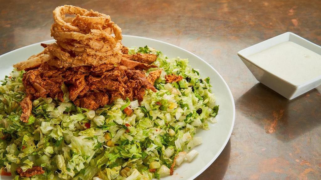 Bbq Chicken Salad · Half Pan - House-smoked pulled BBQ chicken, romaine, iceberg, red leaf, tomatoes, cucumbers, black beans, roasted corn, jicama, crispy buttermilk onion rings, ranch dressing.. Carry out only. Serves 4-6.