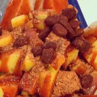 Jicama Loko · A jicama bowl with mangos and cucumbers with peanuts and tamarindo candy bits served with ch...