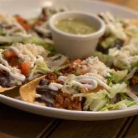 El Cesar Nachos - Choose Your Topping · Lightly fried hand cut tortilla chips topped with black beans, shredded lettuce, queso fresc...