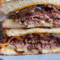 The Super Melt · 2 beef burger patties, served between thick-cut bread & grilled with American cheese, bacon,...